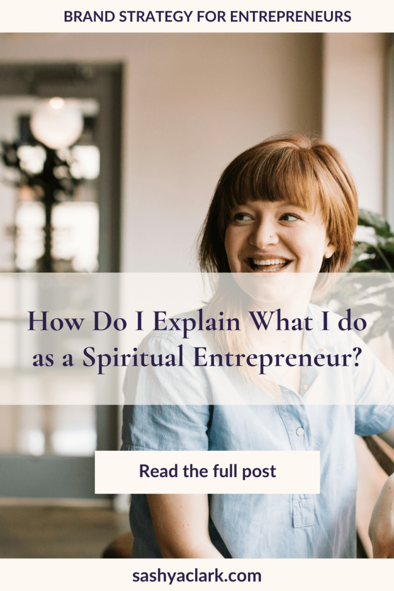 A smiling Woman with red hair and a light blue linen shirt with the caption that says, "How do I explain what I do as a Spiritual Entrepreneur by Sashya Clark Brand Strategist"