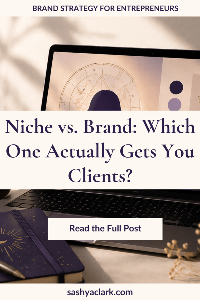 Pinterest pin graphic with cream and navy design. A laptop displays an astrology birth chart on screen alongside navy and lavender color swatches. A celestial moon-design notebook and dried flowers rest below the keyboard. Text reads: Niche vs. Brand: Which One Actually Gets You Clients? Brand strategy for entrepreneurs. sashyaclark.com
